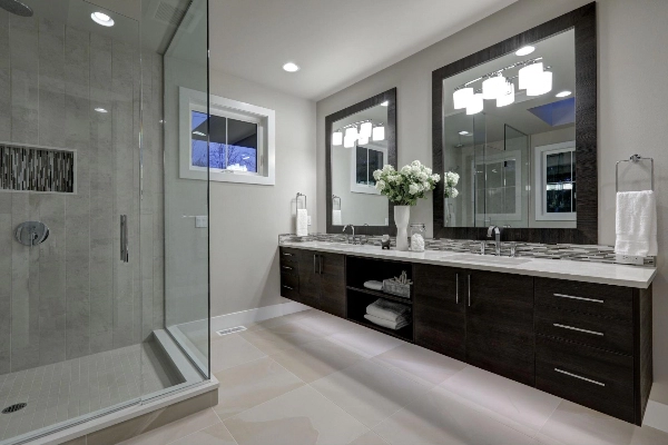 Residential restroom with white tile floor interior and light wall color tone.