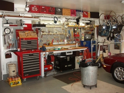 Picture of a workshop bench in front of a red car