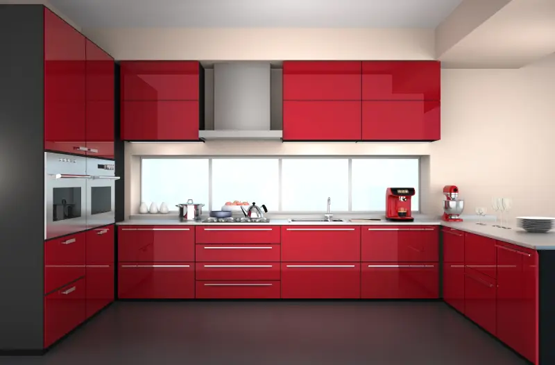 sleek modern kitchen with bright red cabinets paired with red and steel appliance.