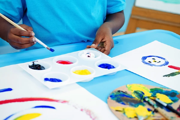 Photo of a person with craft paint all over their hands