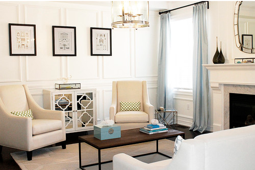 Living room with white walls and a fireplace.