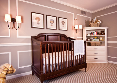 Wooden crib in a mauve-painted bedroom