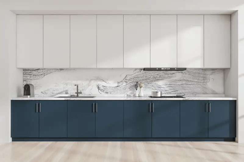 two-toned kitchen with white and navy cabinets paired with a marble back pane