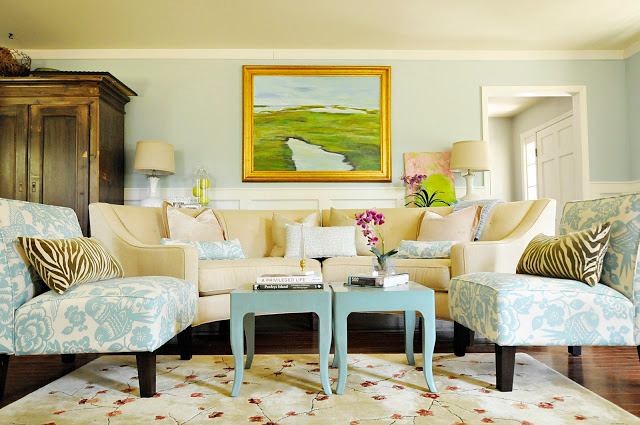 Living room with blue-patterned fabric chairs and cream colored couch