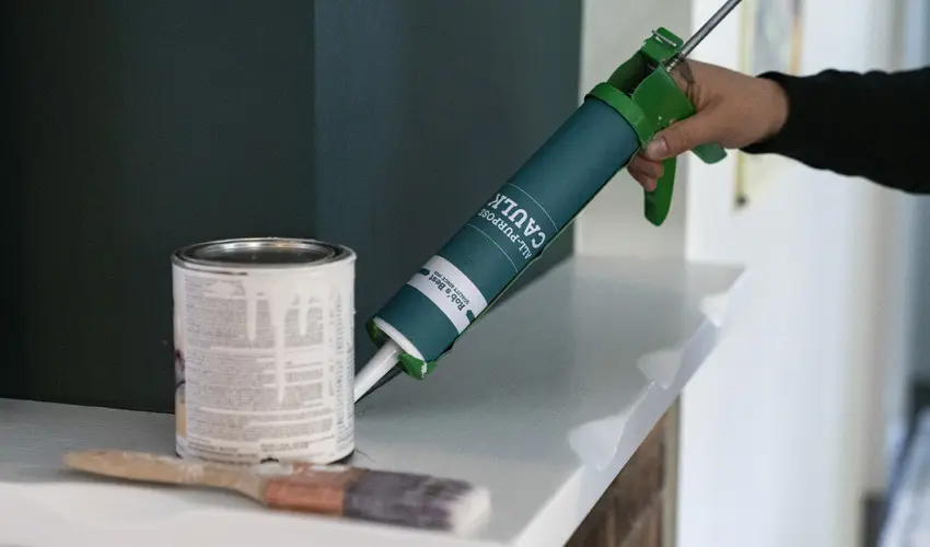 Person using paintable caulk