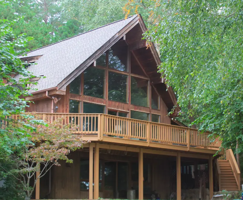 Photo of a wooden cabin surrounded by trees