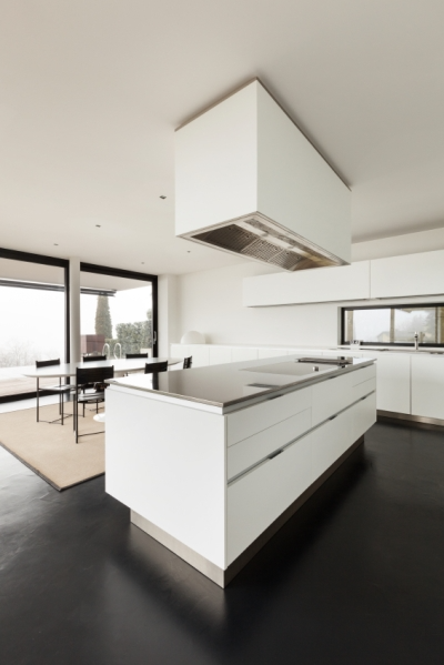 White Kitchen Walls and Cabinets Prevent a Room with Dark Accents from Feeling Small  