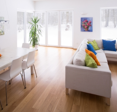 White Walls in Room with Colorful Paintings Hanging Up.