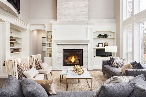 Gorgeous living room painted white with fireplace and bay windows