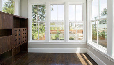 Room with wooden furniture, wooden floor, and white accents