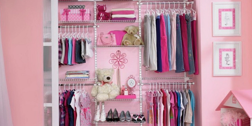 Photo of a child's pink room with an open, organized closet