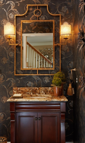 A mohagany colored restroom sink with a mirror 