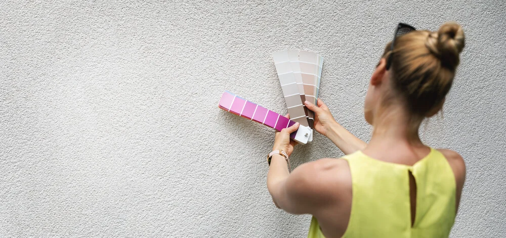 Woman looking at exterior paint swatches.