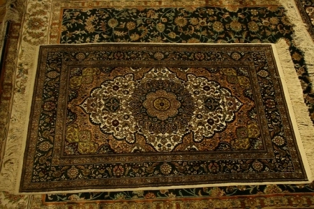 Intricate traditional rug with detailed central medallion and floral motifs.