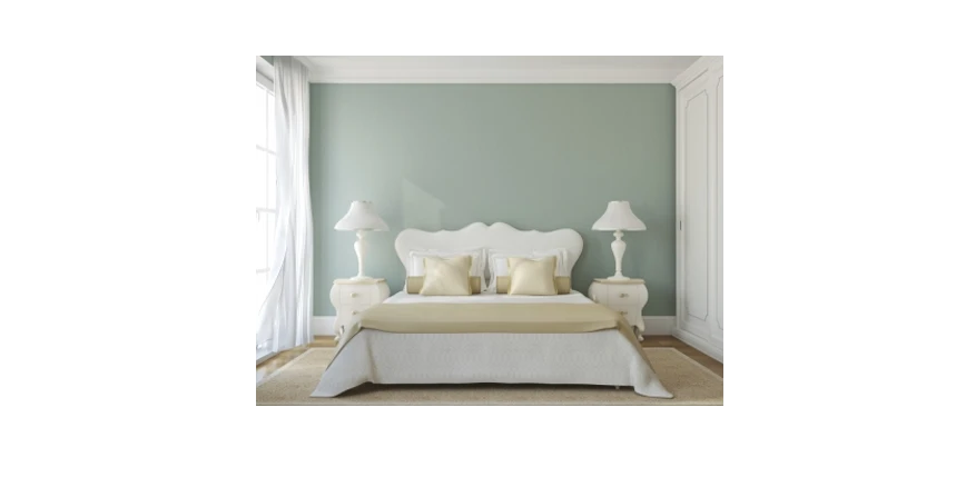 Photo of a bedroom with a sage green accent wall.