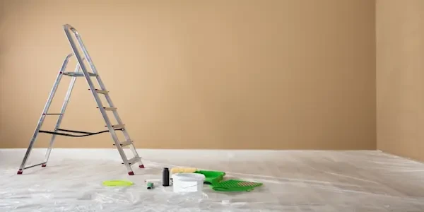 Stepladder with painting supplies on the floor