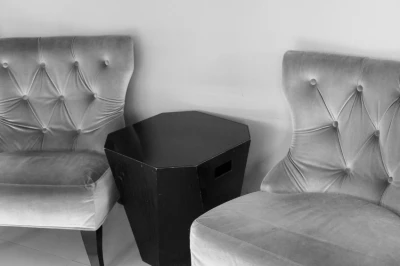 Gray Chairs Flanking Black Side Table