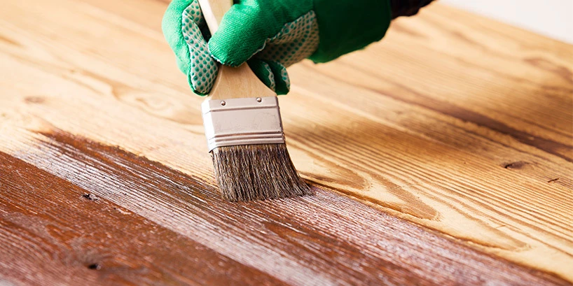 Person painting wood