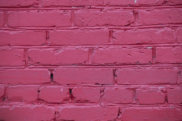 Brick wall painted with red paint