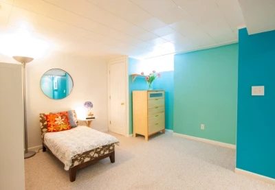 Photo of a bedroom with turquoise accent walls.