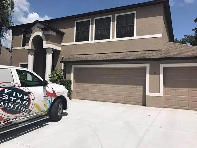 Two story brown house with FSP truck out front