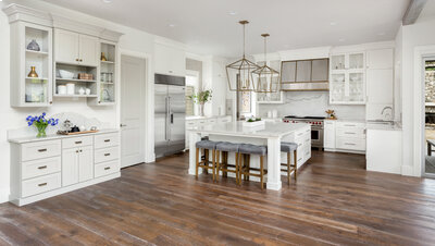 Modern bright kitchen with stainless steel appliances and white cabinets.