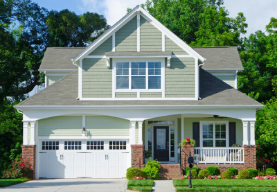 Exterior and front yard of a green two story home.