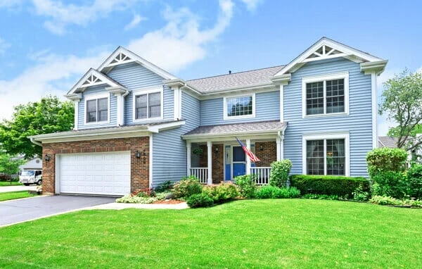 Two-story home with light blue and white exterior paint job.