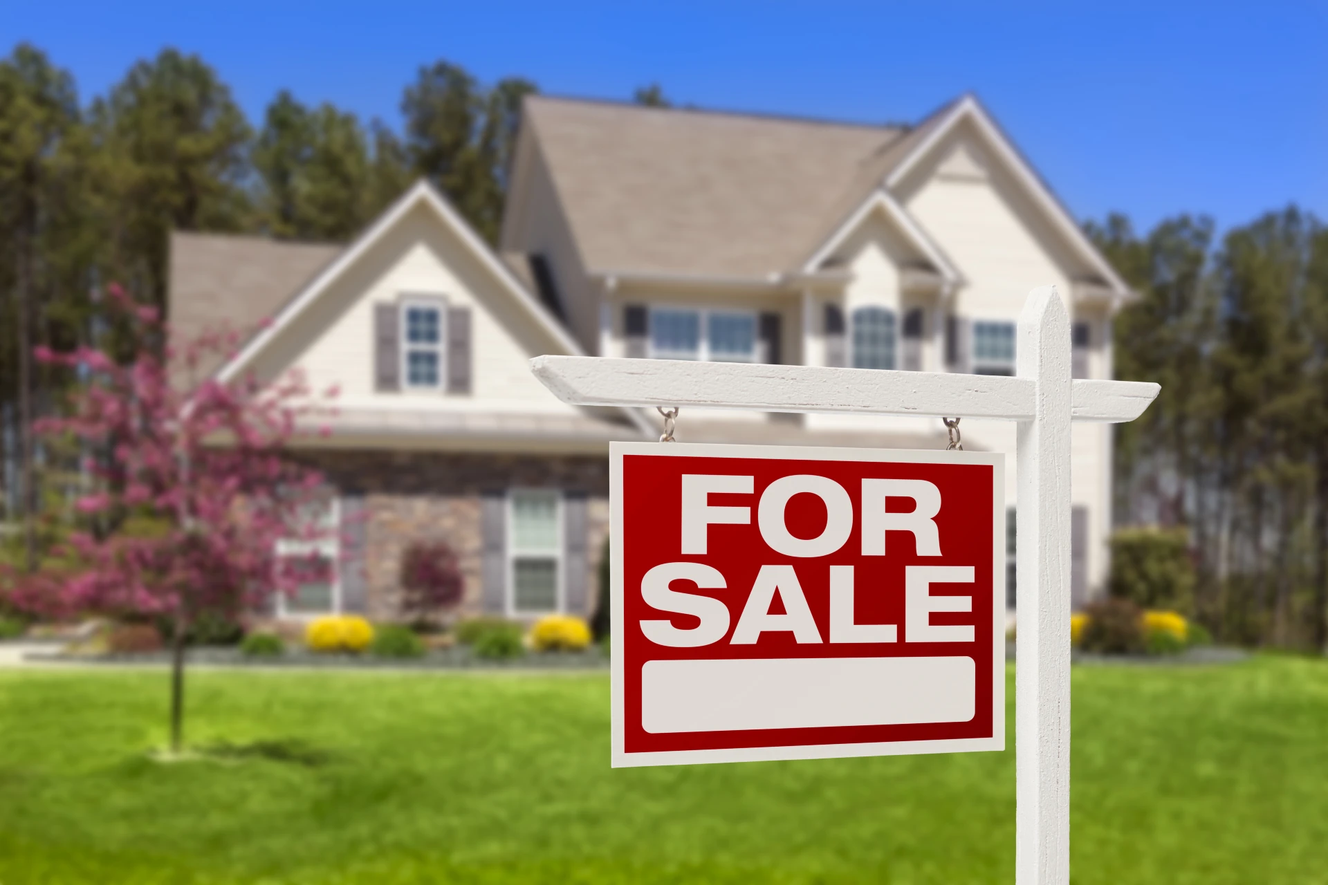 For sale sign in front of a house.
