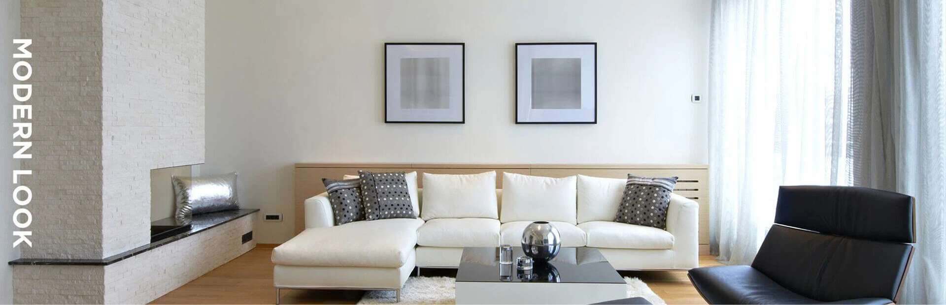 Living Room in original colors of white featuring furniture and paintings on walls.