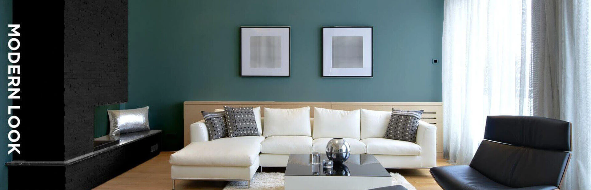 Living room in dark neutral colors featuring furniture and paintings on walls.