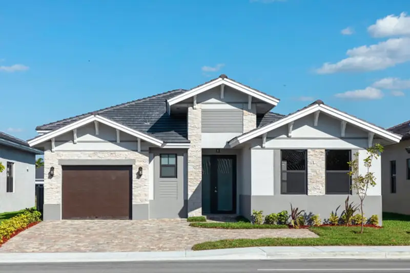 Exterior front view of white house with brown garage door.