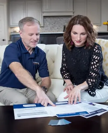 Five Star Painting estimator reviewing service paperwork with homeowner