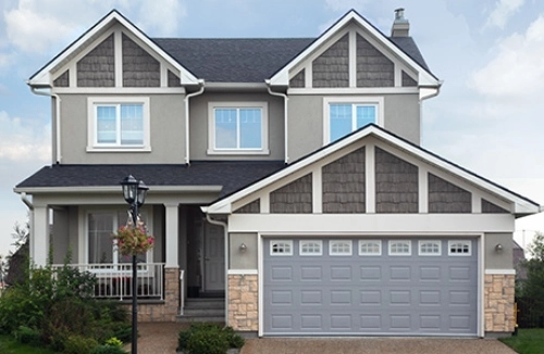 A freshly painted two story home in shades of brown, tan and grey