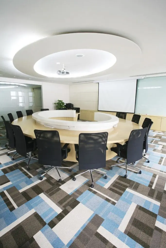 Large conference room with round table and patterned carpet