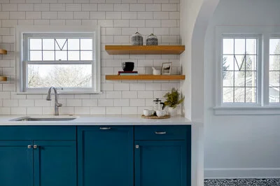 Beautiful modern kitchen with white walls and blue cabinets