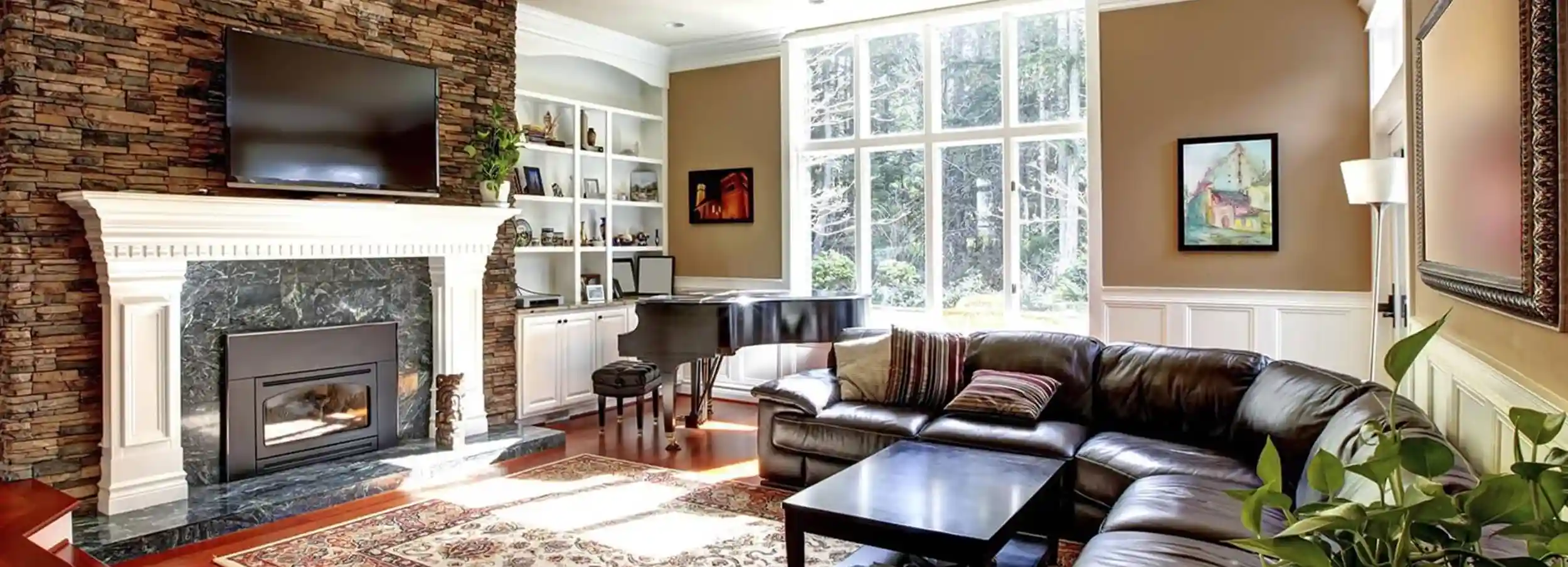 Cozy living room with brick and marble fireplace beside baby grand piano and L-shape sectional leather sofa in opposite corner.