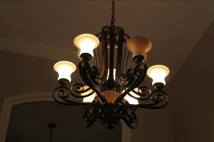 Photo of lighted chandelier in a darkened room