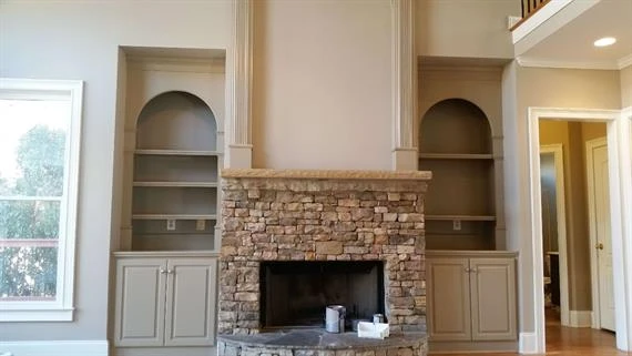 Fireplace flanked by two book cases painted by Five Star Painting of Cumming