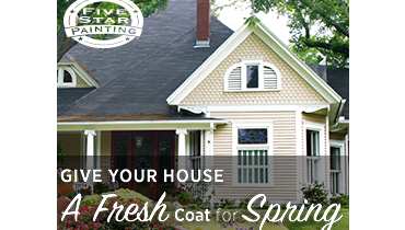 A charming house with a fresh coat of paint, nestled among lush greenery.