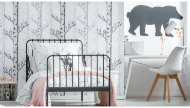 Photo of a bedroom with white birch trees painted on the wall