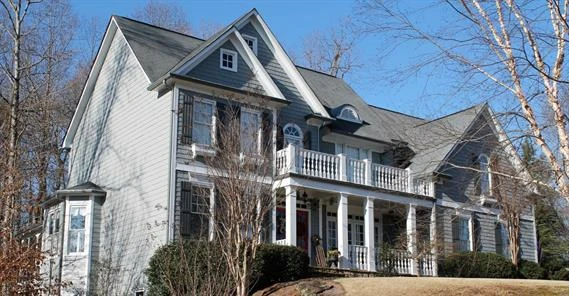 Large, light blue house painted by Five Star Painting of Cumming