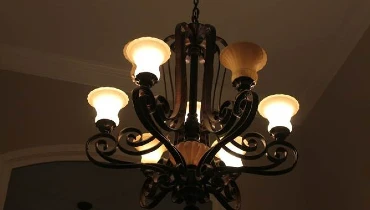 Photo of lighted chandelier in a darkened room