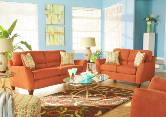 Living room with light blue painted walls and orange couches
