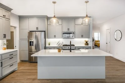 Light gray cabinets and island in a farm-style kitchen