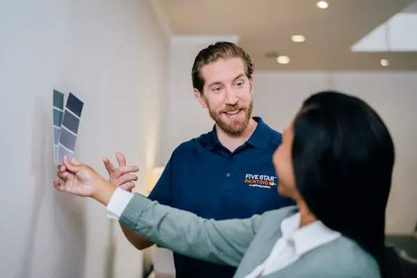 A male FSP technician speaking with a client about paint colors.