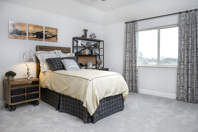 Two-tone bedroom, painted gray with brown wood accents.