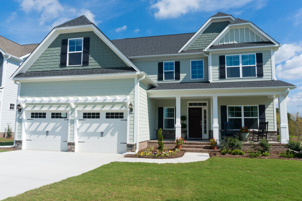 Newly painted house exterior with light and dark green paint