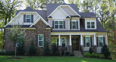 Two-story suburban house with light gray and white exterior paint job