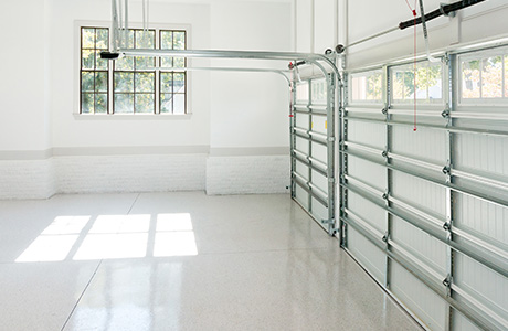 Garage interior with white floors white walls and window
